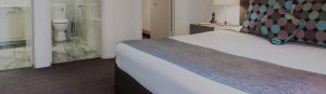Boutique accommodation adelaide; king size bed with view of marble bathroom